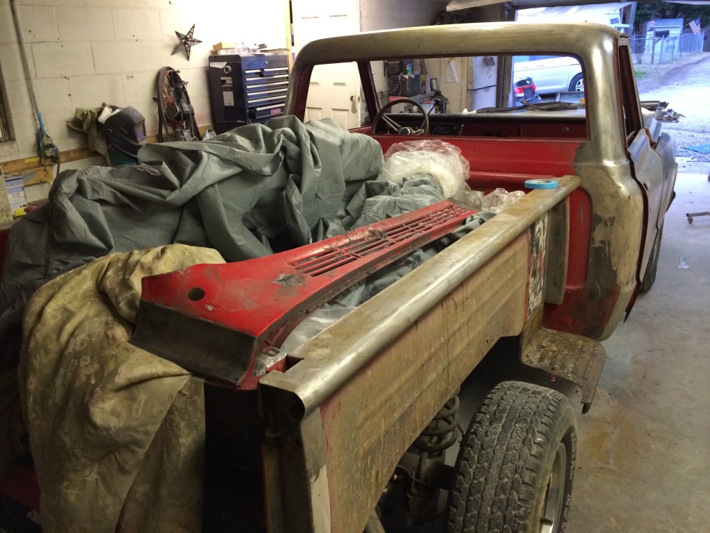 1972 step side Chevrolet truck, stripped for paint, fenders off