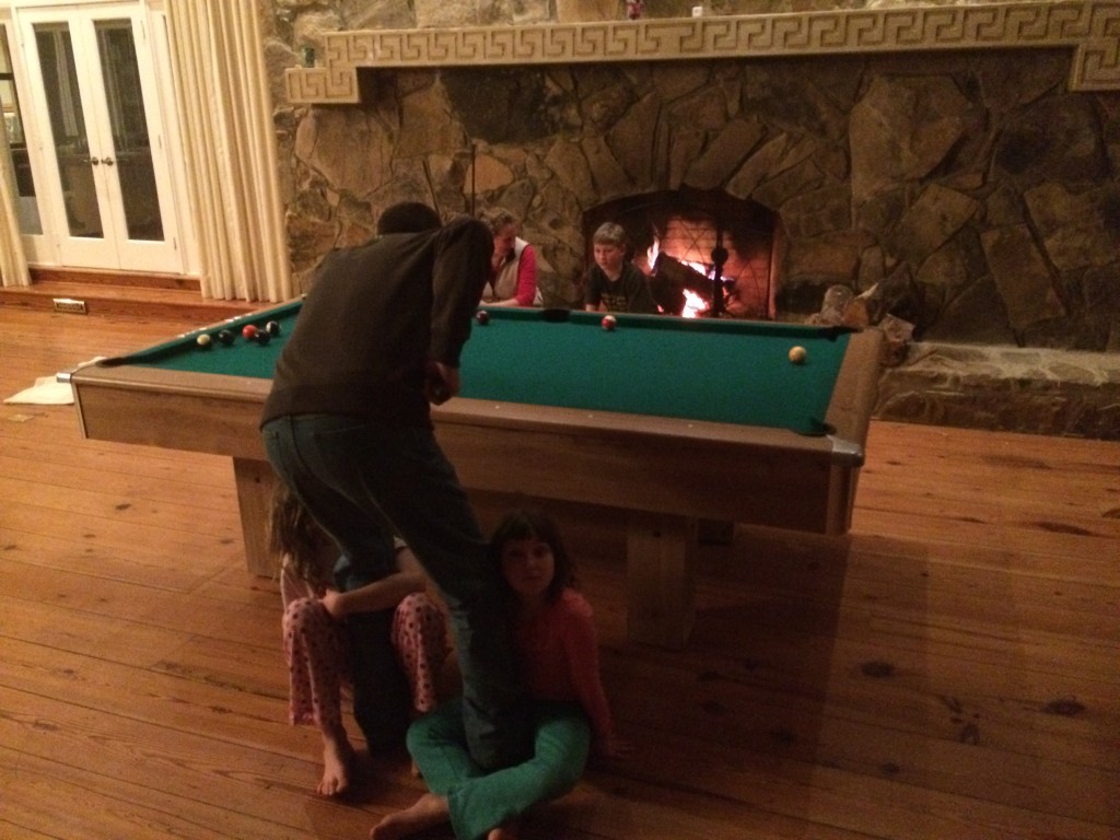 Playing pool with kids and a fireplace