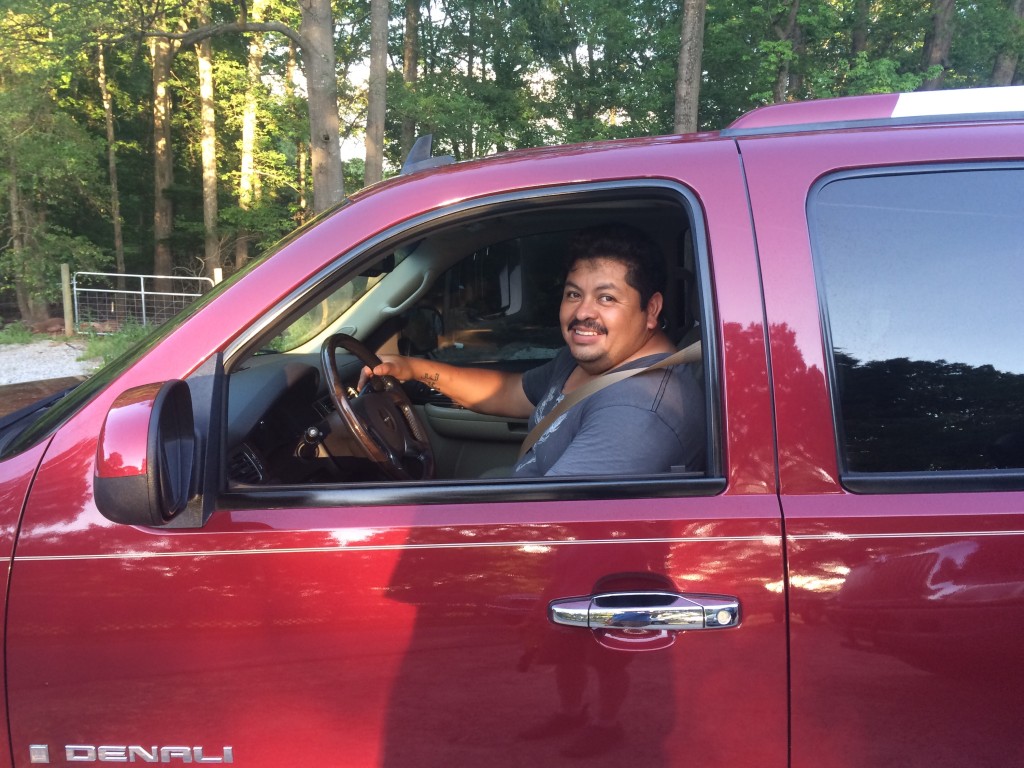 Miguel driving away in his new ride.