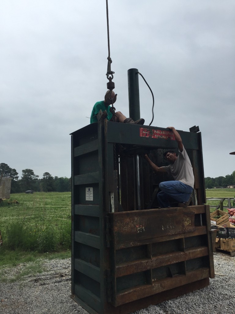 Unhooking the baler from the crane