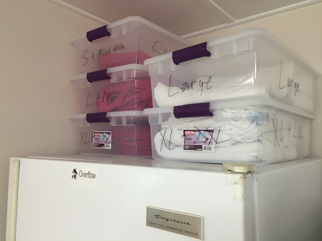 T-shirts stored in plastic bins