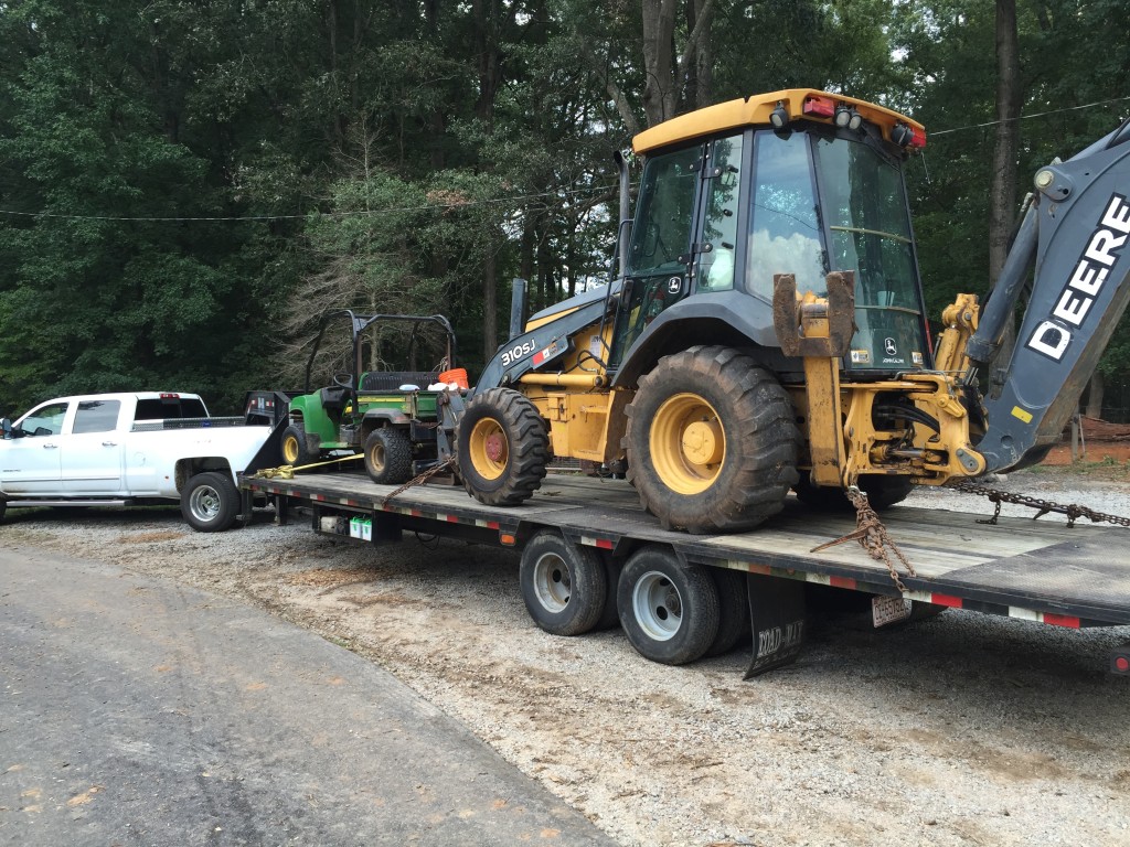 Dually with trailer, JD backhoe, and John Deere Gator