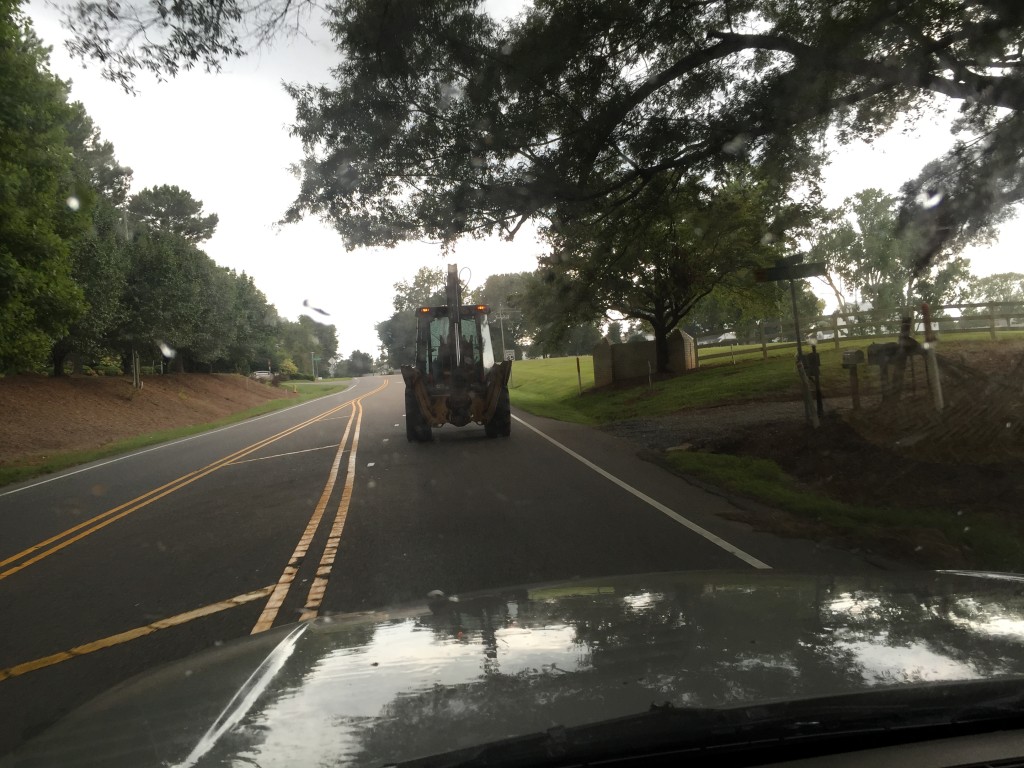 Backhoe driving down the road.