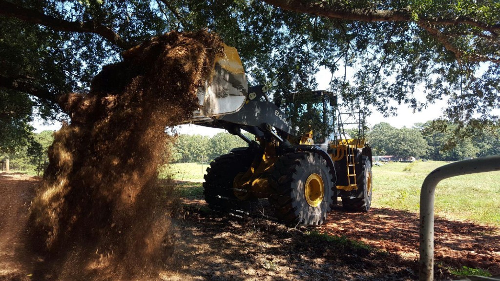 John Deere 844 loader dumping chips