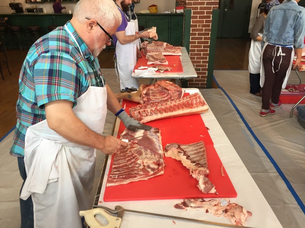 Chef breaking down a side of pork