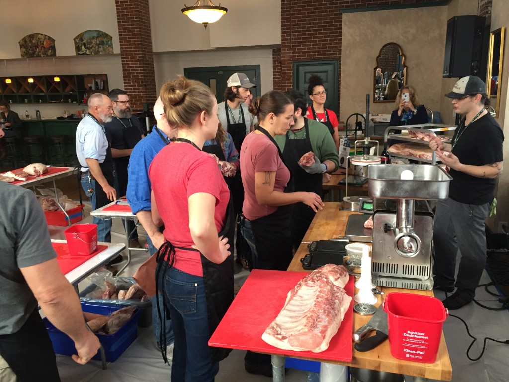 The class going over how to make a particular type of sausage