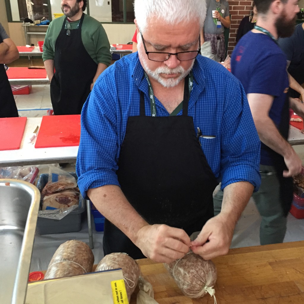 Chef tieing up salami