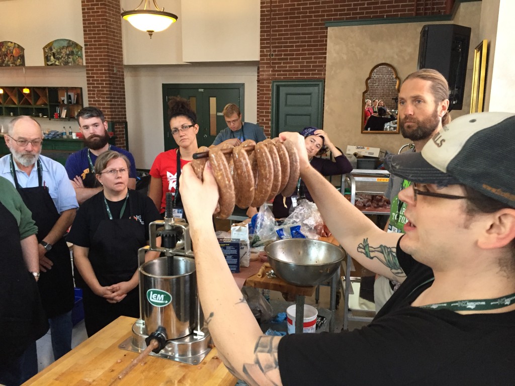 The instructor showing how sausage would be loaded into the smoker