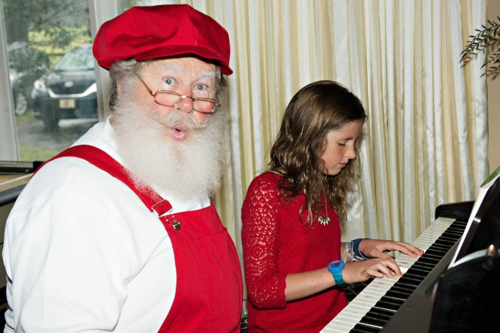 Little girl playing piano for Santa