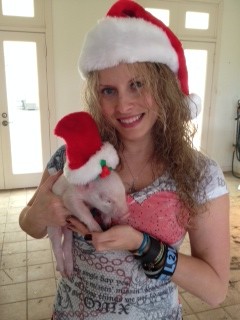 Pretty lady with pig wearing santa hats