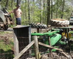 Farmer getting a tractor out of a ditch.