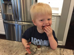 Little boy eating chocolate chip cookie