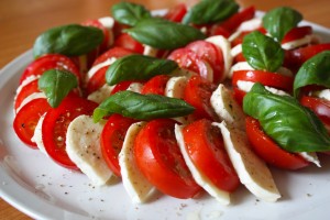 Tomatoes warm from the garden, fresh mozzarella, salt, pepper, and olive oil