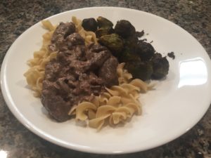 Beef stroganoff over noodles