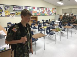 Civil Air Patrol cadet billeting in a classroom.