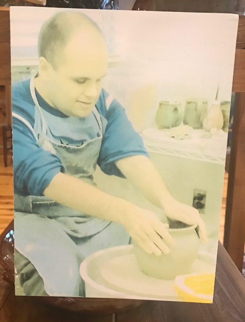 Potter working pottery at the O'Berry center