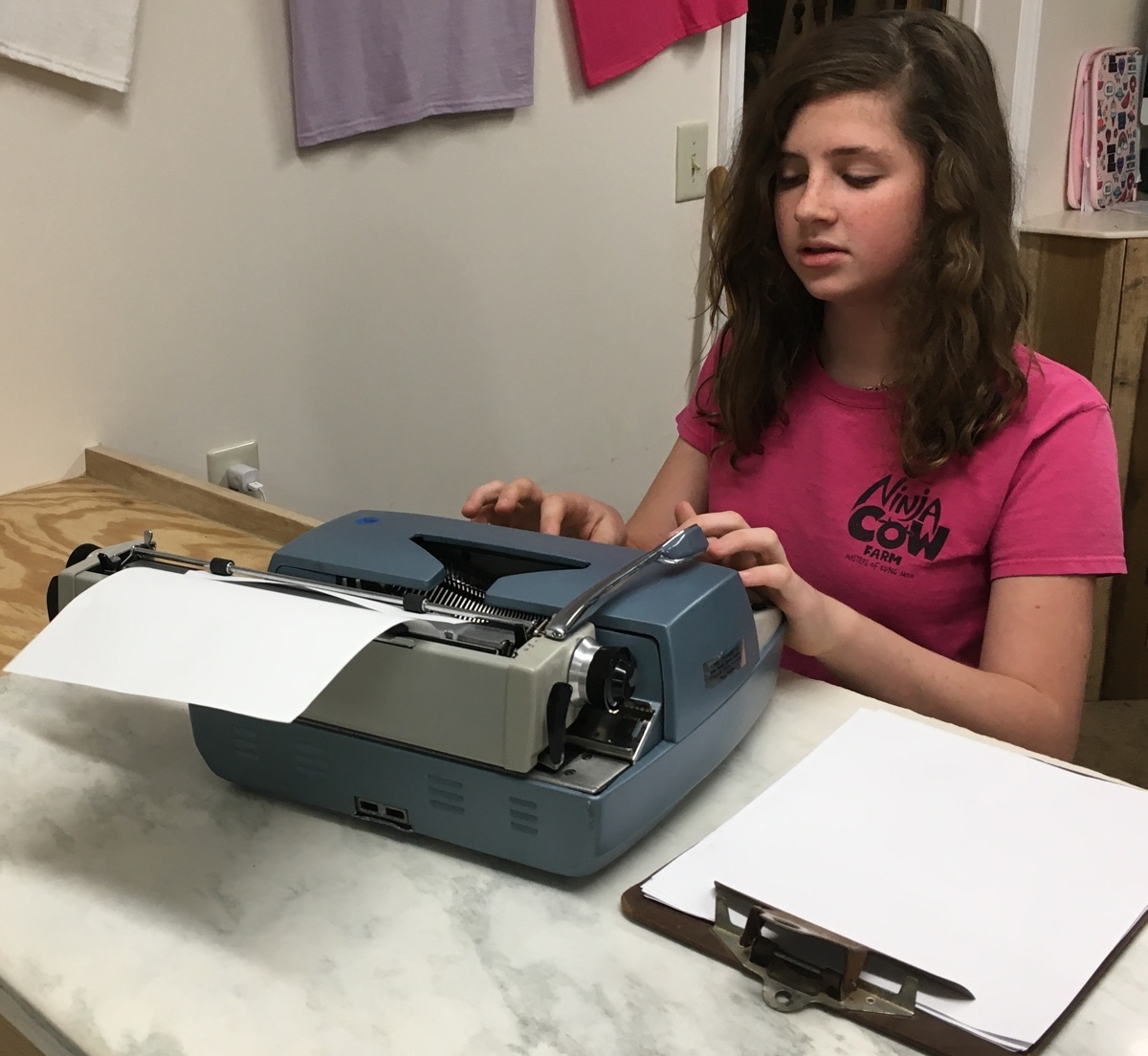 The Princess typing away on an honest to goodness manual typewriter