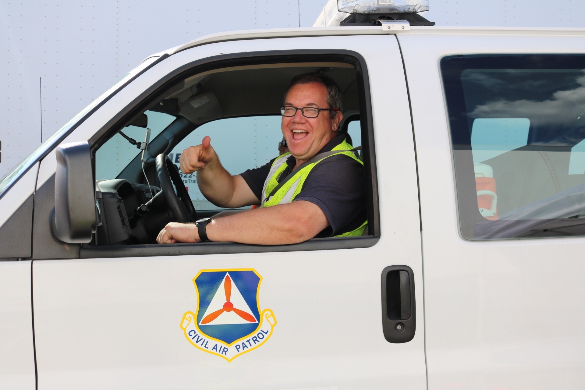 Lt. Col Swindell driving a CAP van and smiling